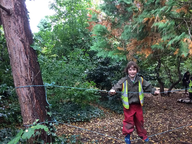 boy walking along rope